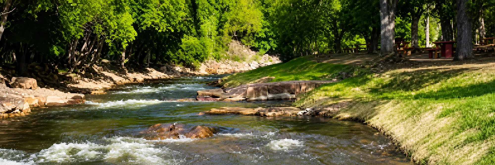 St. Vrain Creek running low between grassy banks